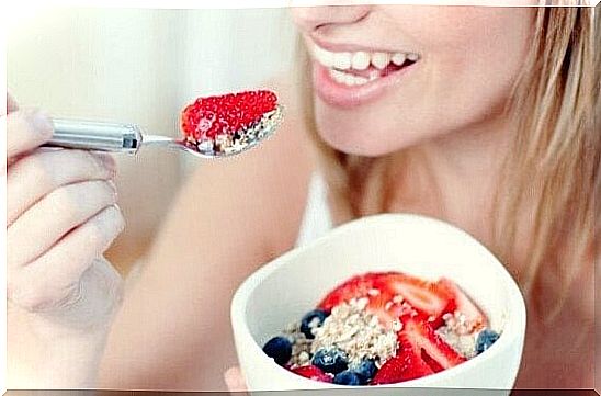 A woman who eats oatmeal with berries to increase serotonin levels.