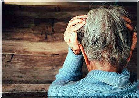 A woman with frontotemporal dementia stares at the floor.