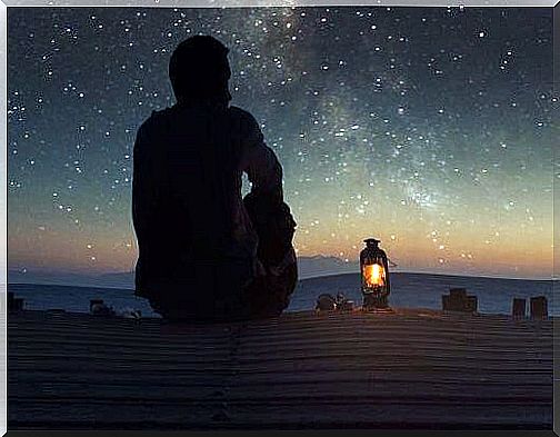 Man on jetty looking at the stars