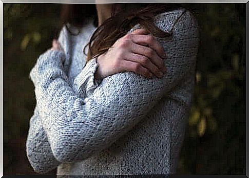 Chronic self-sacrifice: A woman who hugs herself.