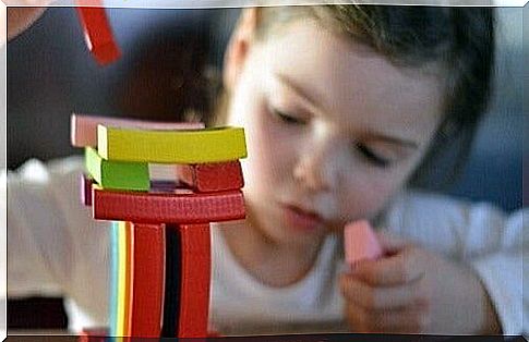 Girl building with bricks.