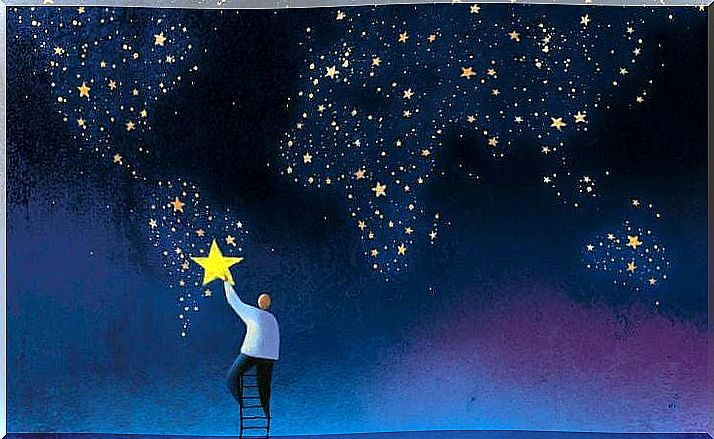 man hanging up stars