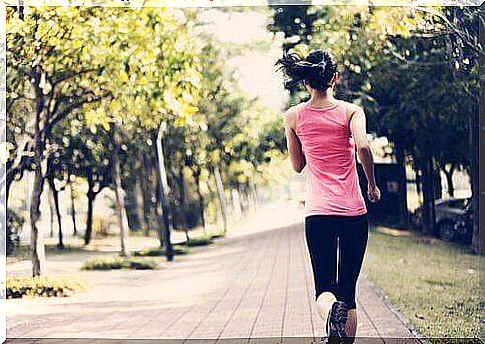 The back of a woman running through a park