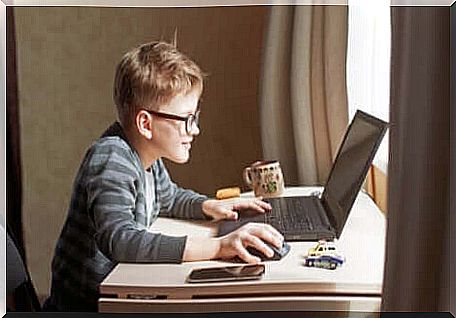 A child playing on a laptop in a world of digitalization.