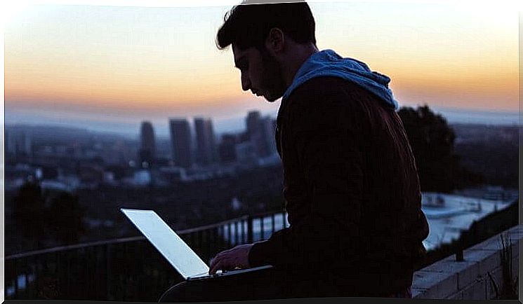 A man who uses a laptop to succeed at work