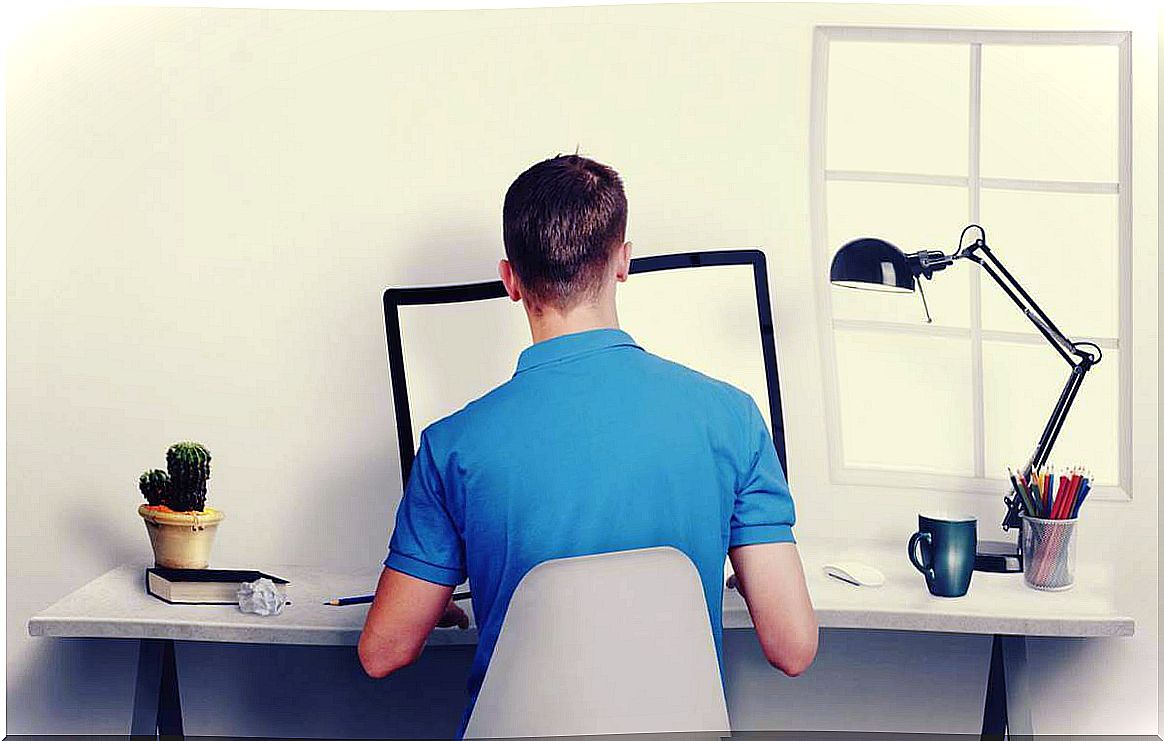 man at the desk representing how to sit upright