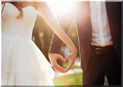 A bride and groom holding hands.