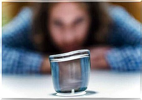 A woman in front of a glass.