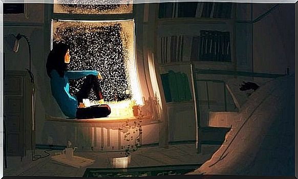 Woman sitting in the window at night