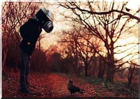 Man with a camera head.