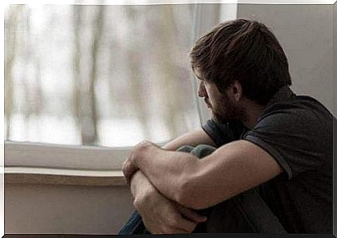 Profile of a man looking out of a window