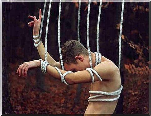 A man tied up in a rope.